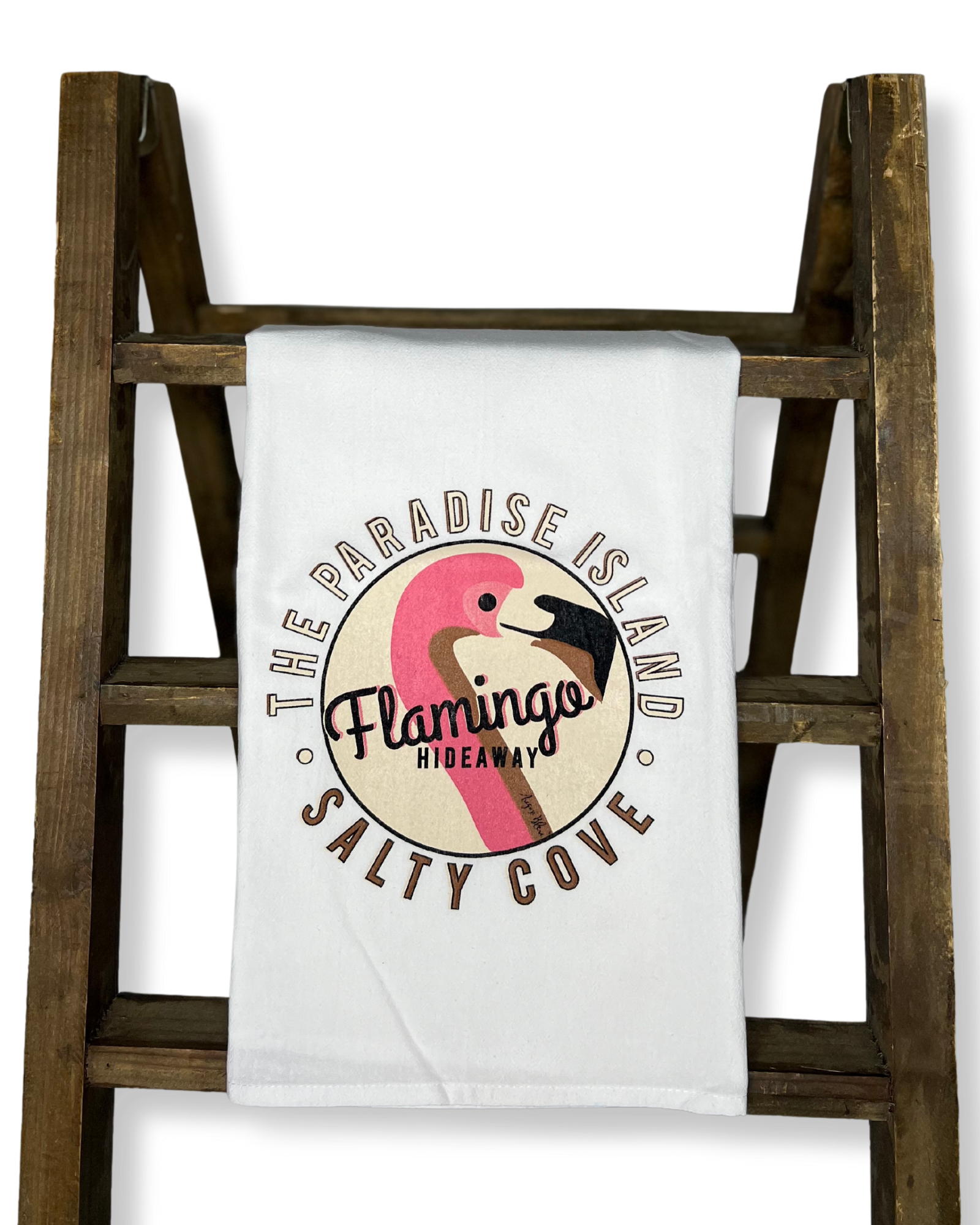 The Paradise Island Salty Cove flamingo hideaway graphic with flamingo art work on a white kitchen tea towel 