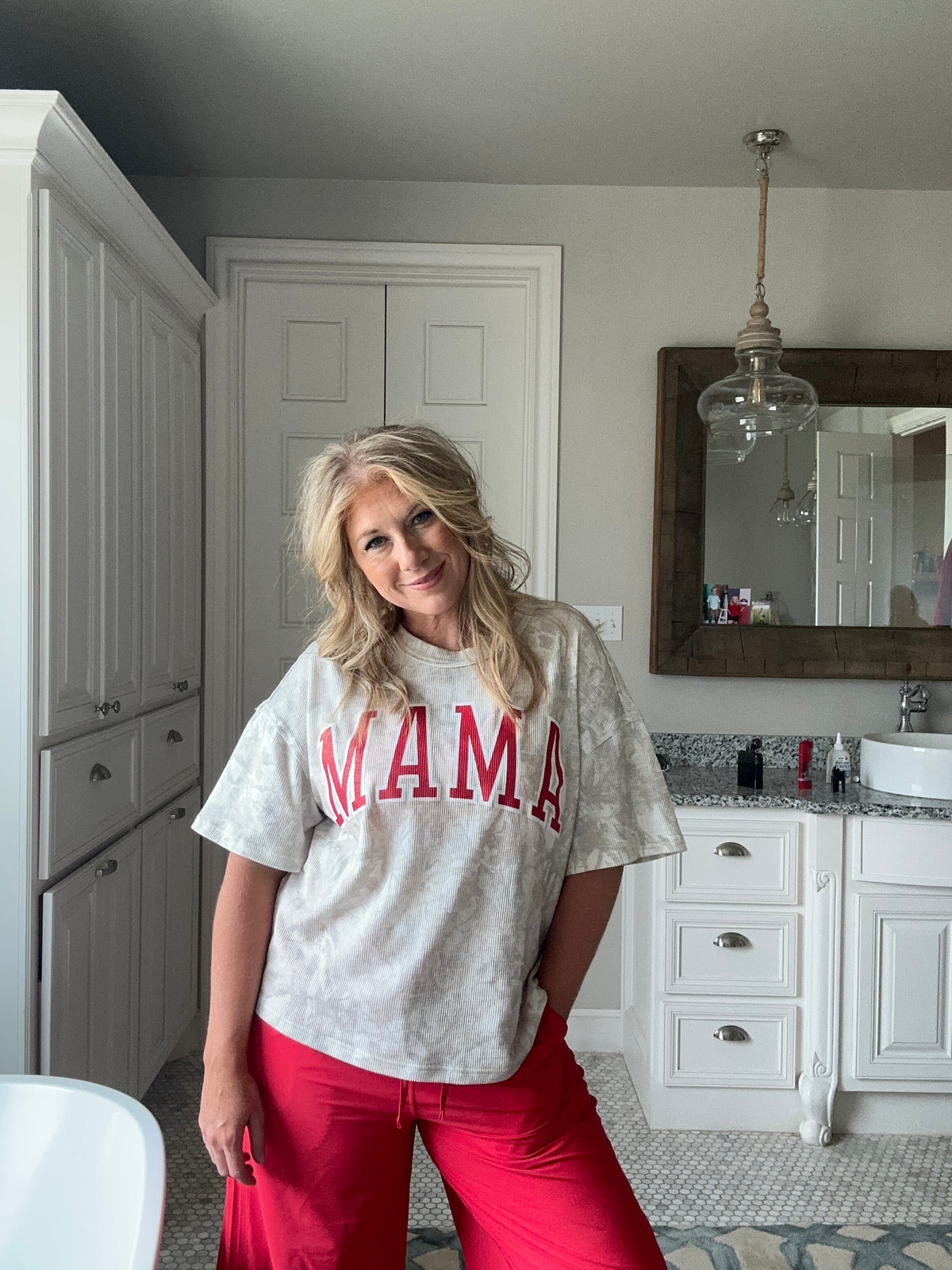Woman in a kitchen wearing a 'MAMA' shirt