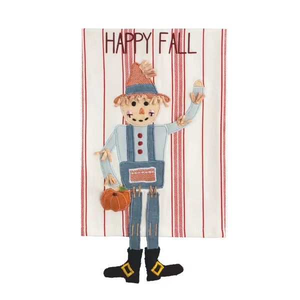 A decorative autumn-themed textile piece featuring a stitched scarecrow holding a small pumpkin, with the words “HAPPY FALL” at the top, shown on a plain white background.