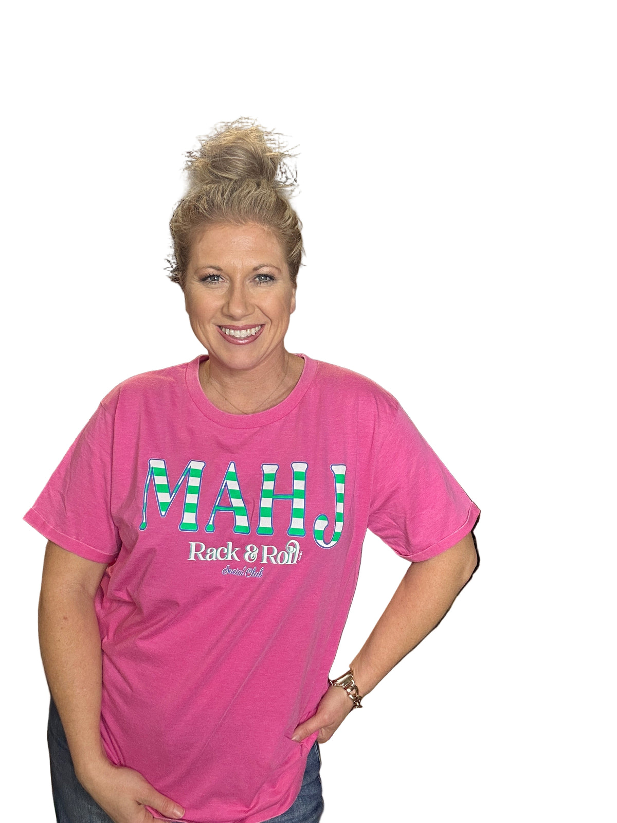 Person wearing a pink t-shirt with text in an indoor setting