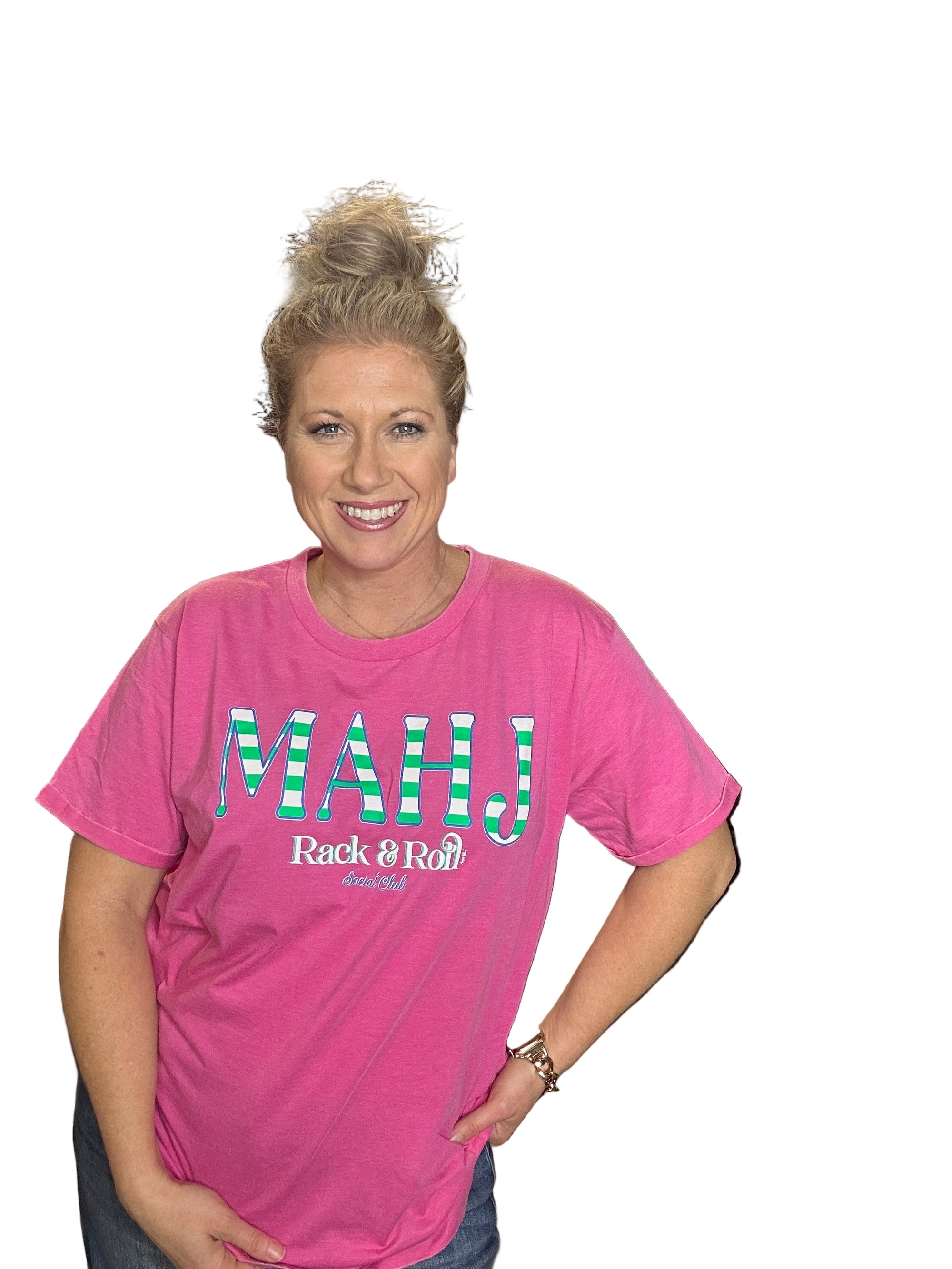 Person wearing a pink t-shirt with text in an indoor setting