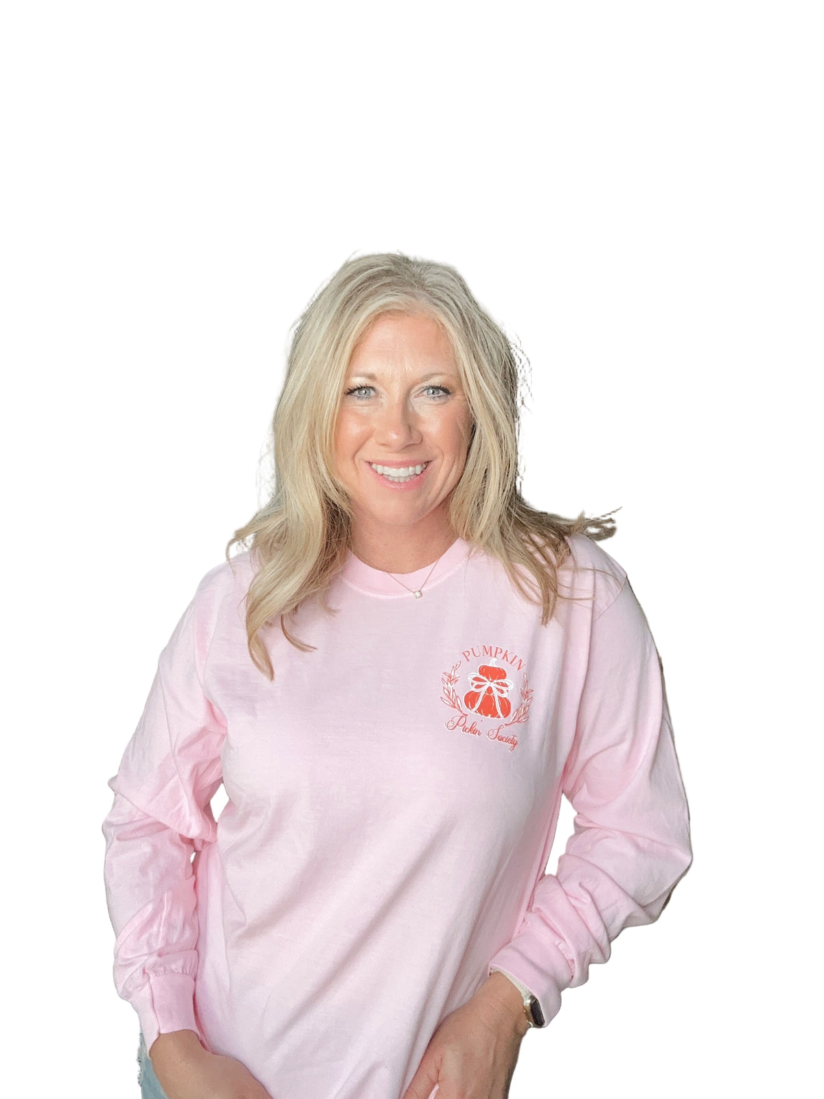 Woman wearing a pink long sleeve with a Pumpkin logo.