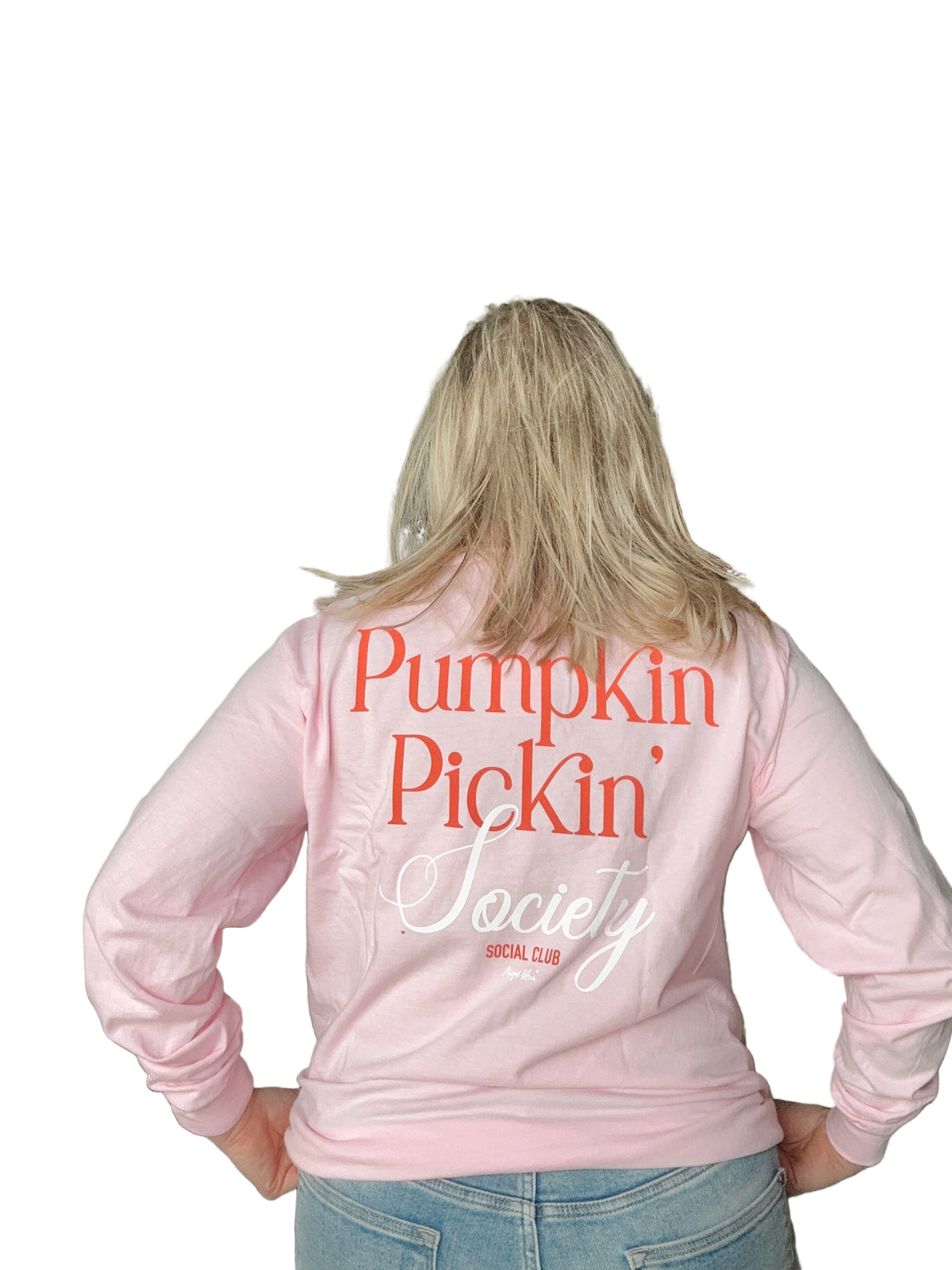 Person wearing a pink long sleeve with &#39;Pumpkin Pickin&#39; Society&#39; text.