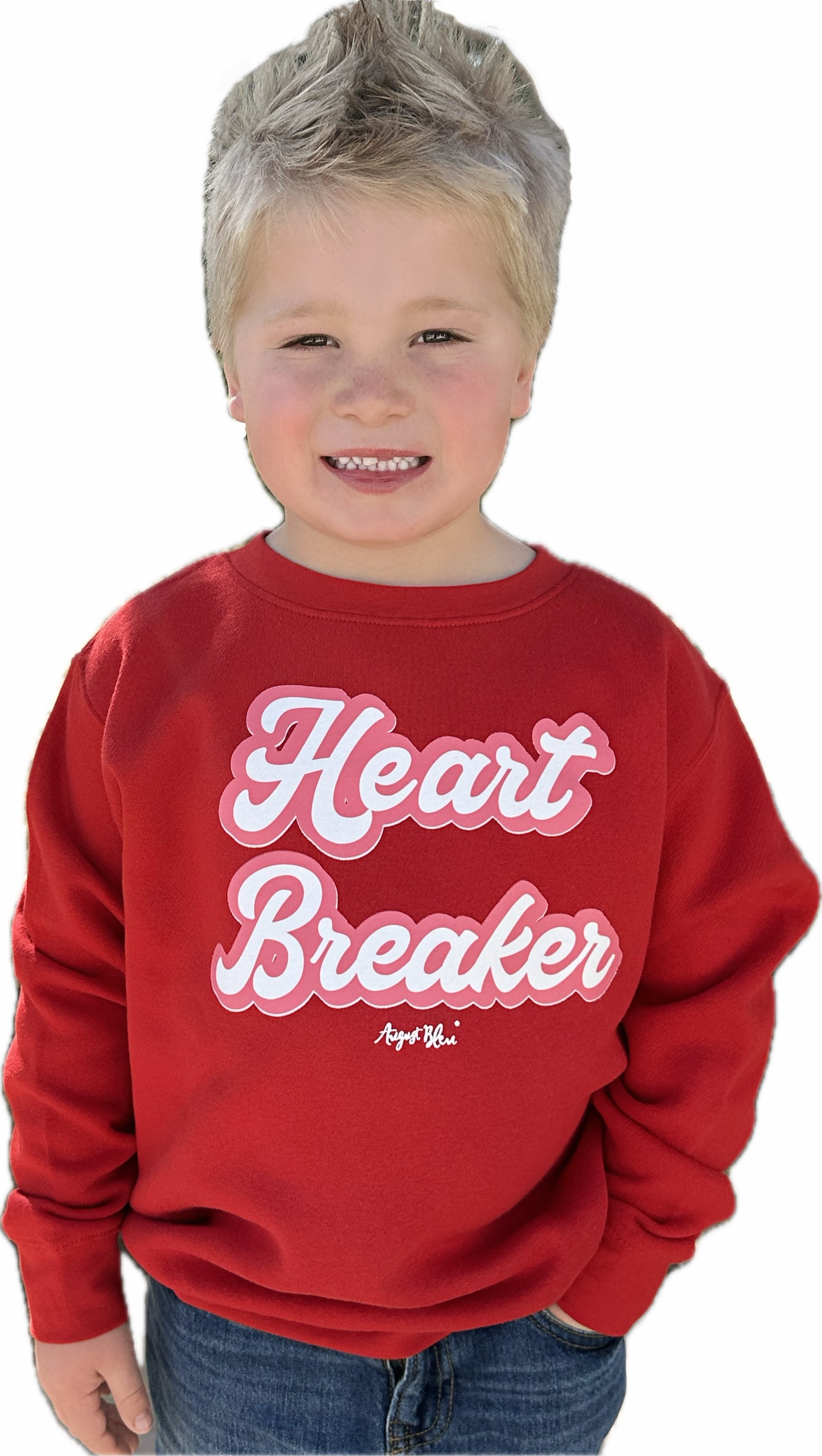 Child wearing a red sweatshirt with 'Heart Breaker' text on a white background