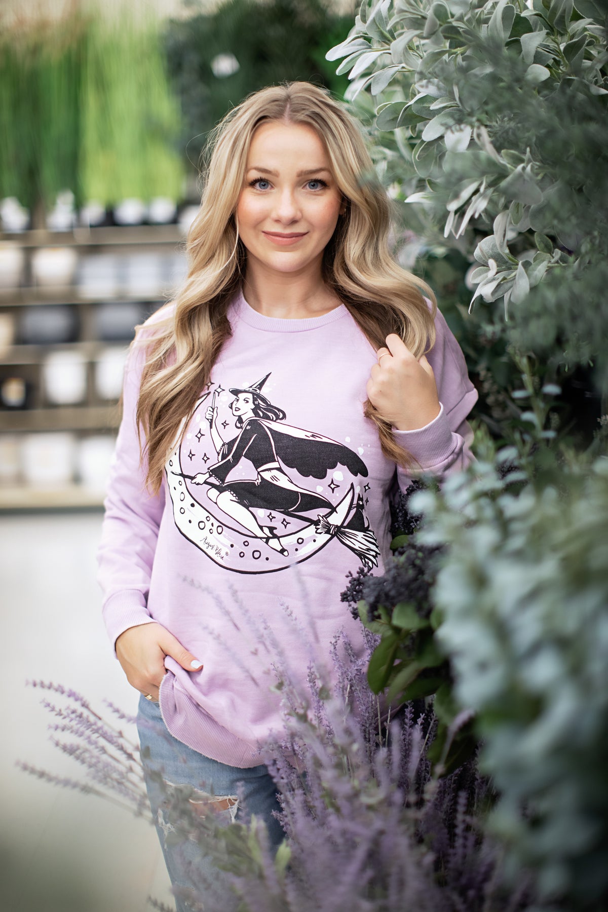 a vnitage witch graphic on a lilac high low pullover style sweatshirt